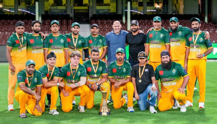 Pakistan team poses for a group photo with the trophy. — reporter