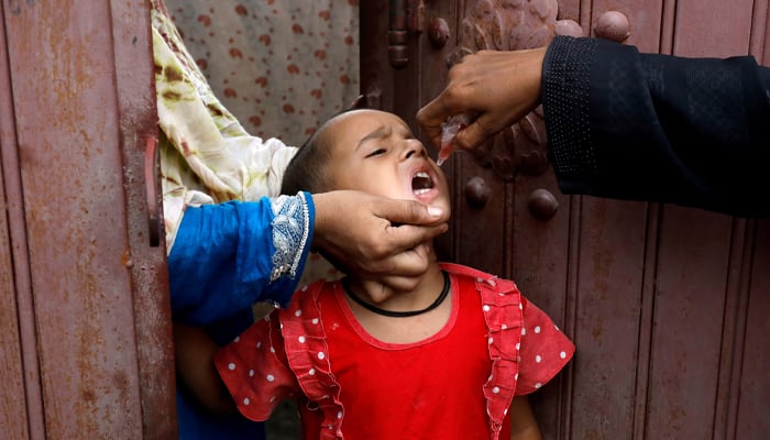 A girl receives polio vaccine drops, during an anti-polio campaign, in a low-income neighborhood as the spread of the coronavirus disease (COVID-19) continues, in Karachi, Pakistan July 20, 2020. — Reuters