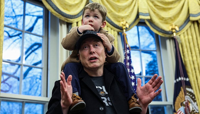 Elon Musk speaks as he carries X Æ A-12 on his shoulders next to U.S. President Donald Trump (not pictured) in the Oval Office of the White House in Washington, D.C., U.S., February 11, 2025. — Reuters