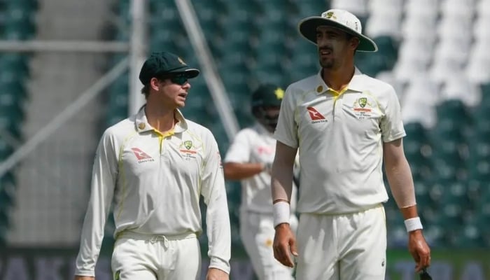 Australias Steve Smith speaks with Australias Mitchell Starc during a Test match between Pakistan and Australia at the Gaddafi Cricket Stadium in Lahore on March 25, 2022. — AFP