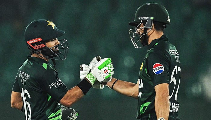 Pakistans captain Mohammad Rizwan (L) celebrates with his teammate Salman Agha after scoring a half-century (50 runs) during the Tri-Nation series third one-day international (ODI) cricket match between Pakistan and South Africa at the National Stadium in Karachi on February 12, 2025. — AFP