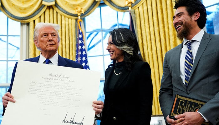 US President Donald Trump, Director of National Intelligence Tulsi Gabbard and her husband Abraham Williams react, on the day of Gabbards swearing in ceremony, in the Oval Office at the White House in Washington, DC, US on February 12, 2025. — Reuters