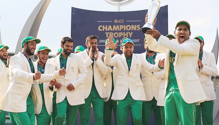 Pakistans then-skipper Sarfaraz Ahmed (right) holds the ICC Men’s Champions Trophy 2017 trophy after winning the tournament. — ICC