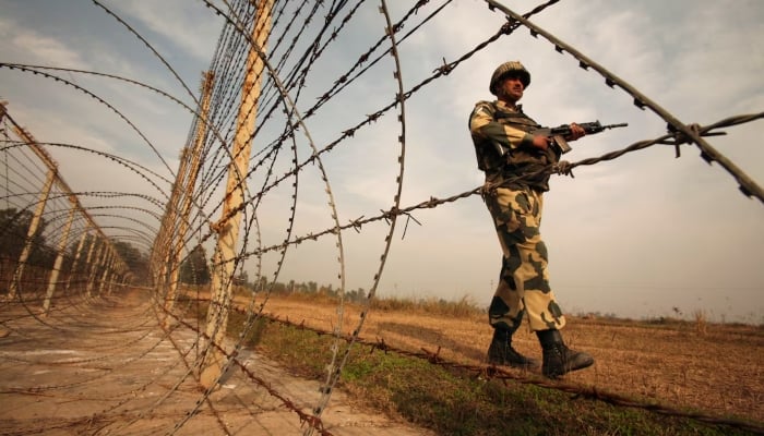 An Indian Border Security Force (BSF) soldier patrols near the Line of Control (LoC) with Pakistan in Suchetgarh, Illegally Indian Occupied Jammu and Kashmir (IIOJK), on January 14, 2013. — Reuters