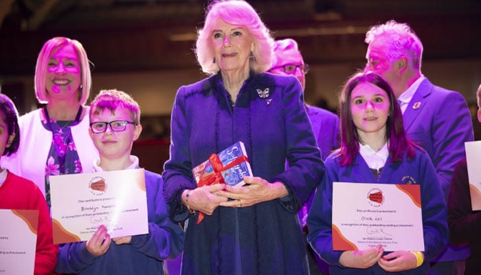 Queen Camilla presents students with their Star Reader certificates