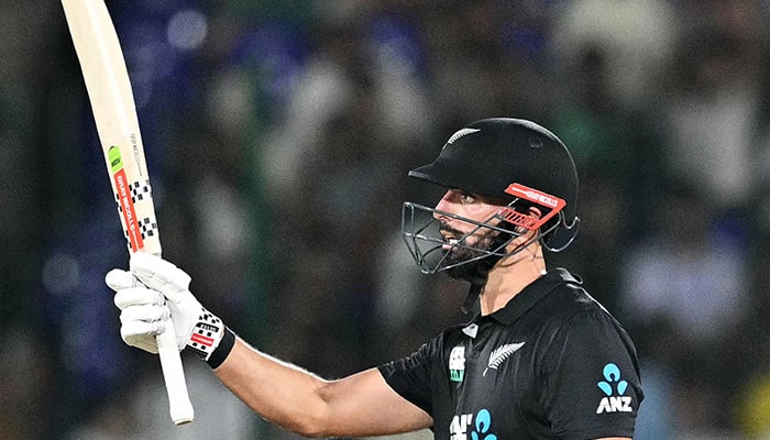 New Zealands Daryl Mitchell celebrates after scoring a half-century (50 runs) during the Tri-Nation series final one-day international (ODI) cricket match between Pakistan and New Zealand at the National Stadium in Karachi on February 14, 2025. — AFP