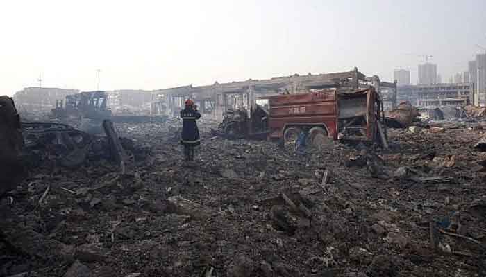 A representational image showing a firefighter recording the aftermath at the site of the explosions in Tianjin on August 15, 2015. — AFP