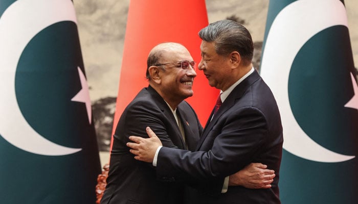 Chinese President Xi Jinping (right) interacts with President Asif Ali Zardari at a signing ceremony in the Great Hall of the People in Beijing on February 5, 2025. — AFP