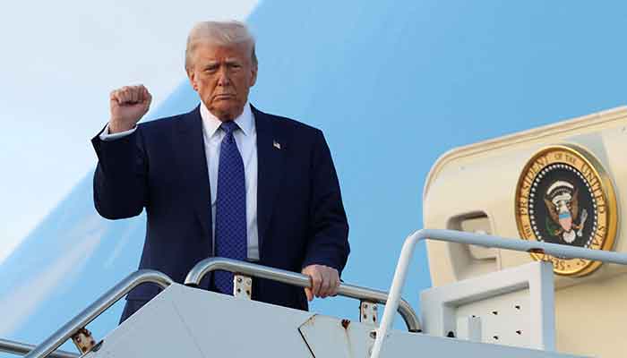 US President Donald Trump raises his fist upon arrival in West Palm Beach, Florida, US, February 14, 2025. — Reuters