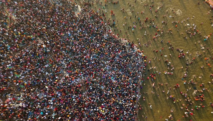 Thousands of Hindu devotees are seen taking a dip in the Triveni Sangam at Kumbh-2025, Prayagraj. — X@myogioffice