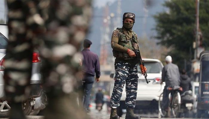 An Indian soldier stands with a gun in his hands during a curfew in the Indian Illegally Occupied Jammu and Kashmir (IIOJK). — Reuters/File