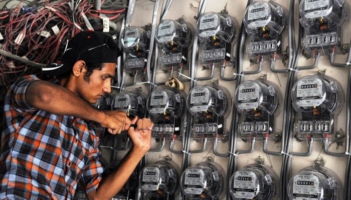 A technician fixes the electricity meter on this undated photo. - AFP / File