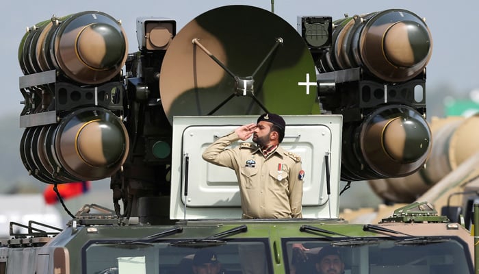 Pakistani Army soldier salutes while standing on an air defence missile system during Pakistan Day military parade in Islamabad, Pakistan, March 23, 2022. — Reuters