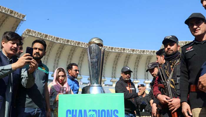 People with their mobile phones take photos of the ICC Champions trophy, during a ceremony at the Arbab Niaz Cricket Stadium in Peshawar, Pakistan, February 6, 2025. — Reuters