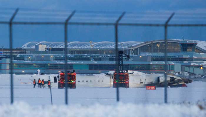 Emergency responders operate around a plane on a runway after a plane crash at Toronto Pearson International Airport in Mississauga, Ontario, Canada February 17, 2025. — Reuters