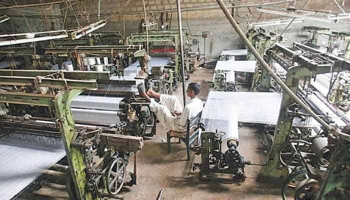 An undated image of a worker sitting idle in a textile factory. — Reuters/File