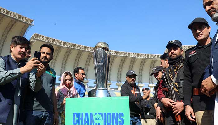 People with their mobile phones take photos of the ICC Champions trophy, during a ceremony at the Arbab Niaz Cricket Stadium in Peshawar, February 6, 2025. — Reuters