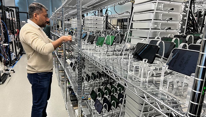 An Apple engineer stress tests an iPhone 16e and the new C1 cellular modem at an Apple lab in Sunnyvale, California, US, February 18, 2025. — Reuters