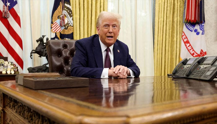 US President Donald Trump sits in the Oval Office of the White House, as he signs executive orders, in Washington, US, January 23, 2025. — Reuters