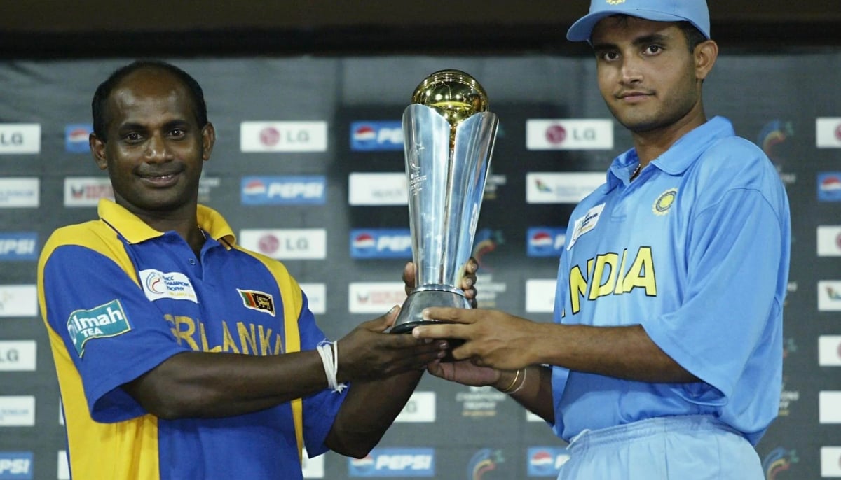 Former Sri Lankan captain Sanath Jayasuriya (left) and former Indian captain Saurav Ganguly pose with the shared trophy after the Champions Trophy final was declared a draw in 2002. — ICC/File