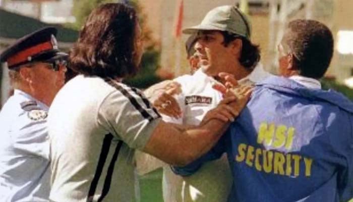 This undated photo shows angry Inzamam is held back by security officials. — ESPNcricinfo