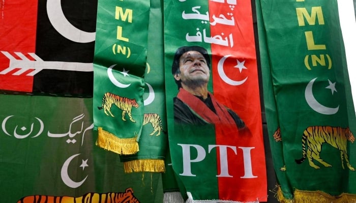 Flags of  political parties are displayed for sale at a market in Lahore on January 13, 2024. — AFP