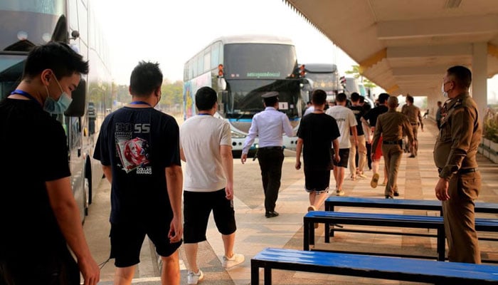 Rescued foreigners, included 109 Thais, 50 Pakistanis, 48 Indians, five Taiwanese and three Indonesians, are being transported to a location via buses by Thai and Cambodian police on February 23, 2025. — AFP