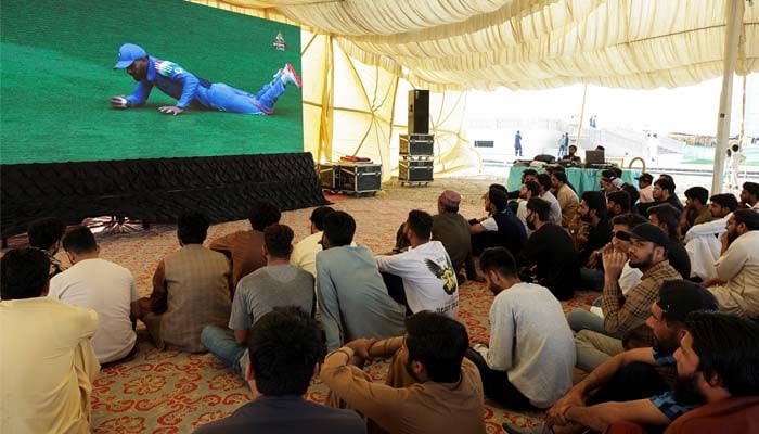 Pakistani cricket fans watch a match between India and Pakistan on a big screen, during the ICC Mens Champions Trophy, in Karachi, Pakistan, February 23, 2025. — Reuters