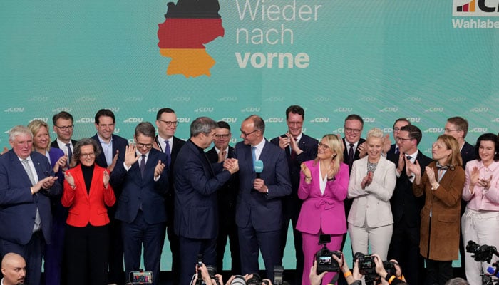 German conservative candidate for chancellor and Christian Democratic Union (CDU) party leader Friedrich Merz and Bavarian state premier and Christian Social Union (CSU) leader Markus Soeder react after the exit poll results are announced in the German general election in Berlin, Germany, February 23, 2025. — Reuters