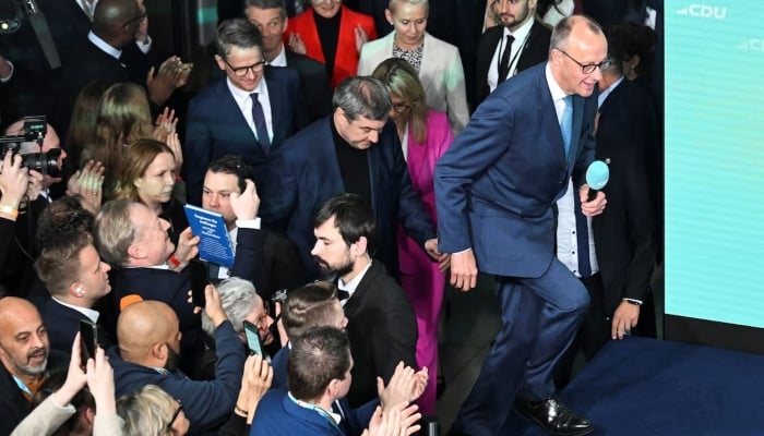 German conservative candidate for chancellor and Christian Democratic Union (CDU) party leader Friedrich Merz and Markus Soeder, Bavaria state premier and leader of the Christian Social Union (CSU) enter the stage after the exit poll results are announced for the 2025 general election, in Berlin, Germany, February 23, 2025. — Reuters