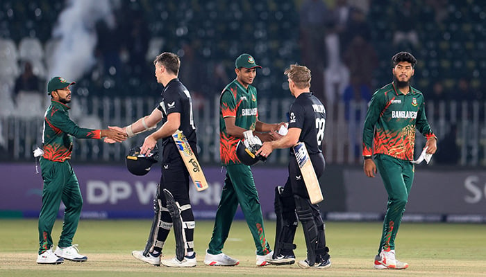 New Zealands Michael Bracewell and Glenn Phillips shake hands with Bangladesh players after winning the match. — Reuters