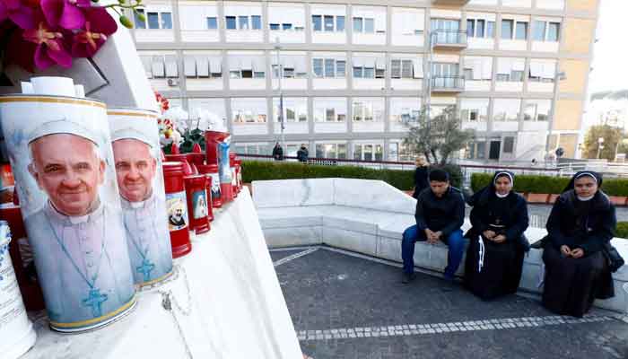 People pray outside the Gemelli Hospital where Pope Francis is admitted for treatment, in Rome, Italy, February 22, 2025. — Reuters