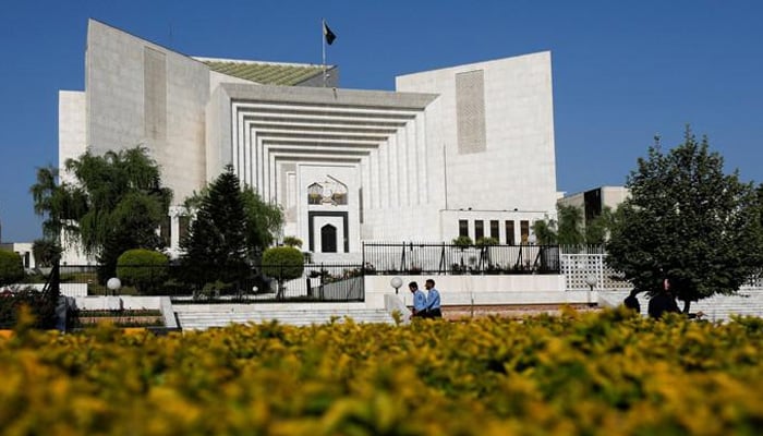 Police officers walk past the Supreme Court of Pakistan building, in Islamabad, April 6, 2022. — Reuters