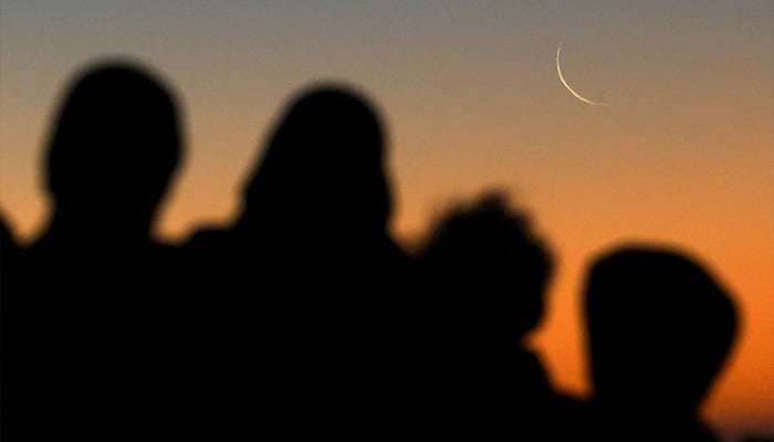 Muslims look at the sighting of the crescent moon that marks the start of the holy month of Ramadan on Sea Point promenade in Cape Town, South Africa. — Reuters