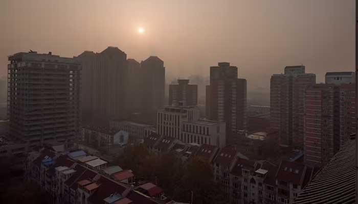 The sun rises over the city on a polluted morning in Beijing, China, November 18, 2021. — Reuters