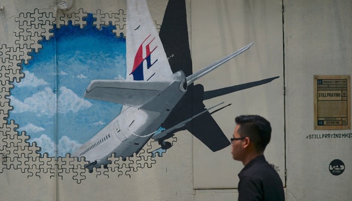 A mural representing the missing Malaysia Airlines flight MH370 at an alley near Kuala Lumpur. AFP/File