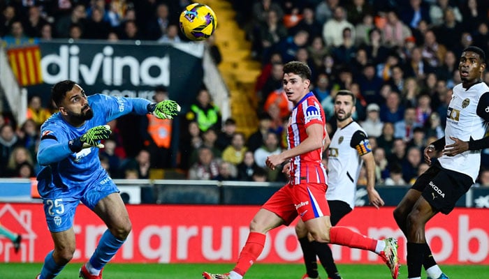 Atletico Madrids Argentine forward #19 Julian Alvarez (C) scores their second goal past Valencias Georgian goalkeeper #25 Giorgi Mamardashvili during the Spanish league football match between Valencia CF and Club Atletico de Madrid at Mestalla Stadium in Valencia on February 22, 2025. — AFP