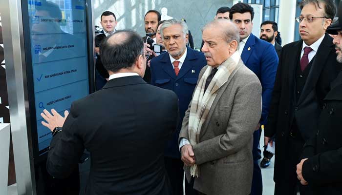 Prime Minister Shehbaz Sharif being briefed by Ulvi Mehdiyev, chairman of the State Agency for Public Service and Social Innovation about the services offered by Asan Khidmat during his visit to one of the centers in Baku, Azerbaijan on February 25, 2025. — PID