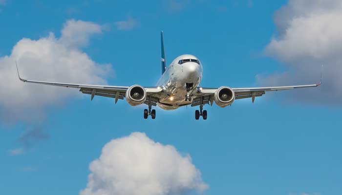 This representational image shows an airplane in the sky. — Unsplash