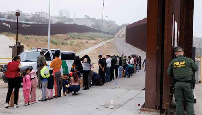 US Border Patrol agents gather and sort migrants who overnight gathered between the primary and secondary border walls that separate Mexico and the United States following the announcement of tough new restrictions imposed by US President Biden in San Diego, California,US, June 6, 2024. — Reuters