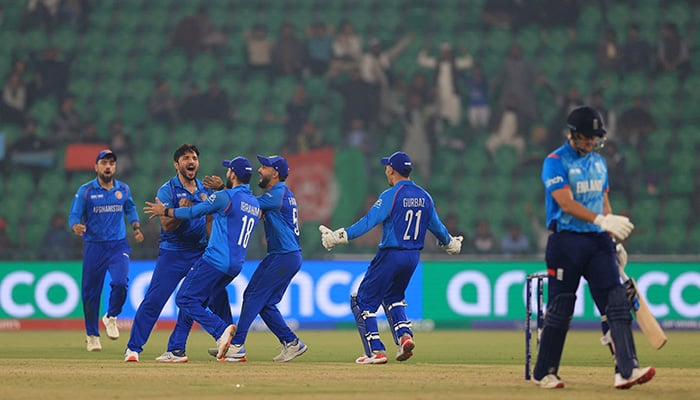 Afghanistans Gulbadin Naib celebrates taking the wicket of Englands Liam Livingstone with teammates. — Reuters