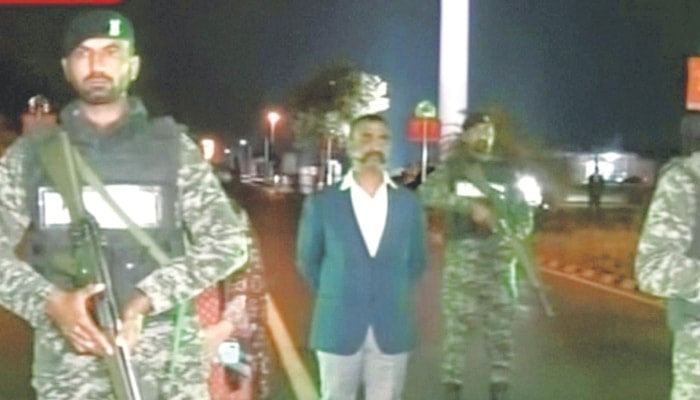 IAF Wing Commander Abhinandan Varthaman (centre) waits for his return to India at the Wagah border crossing on March 01, 2019. — Reuters