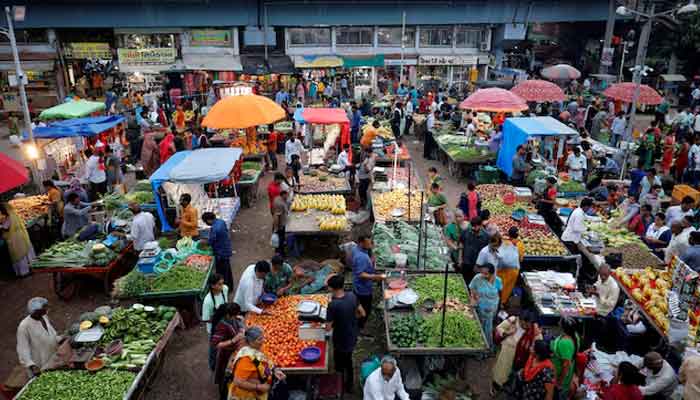 Customers buy fruit and vegetables on an outdoor market in Ahmedabad, India, August 21, 2023. - Reuters