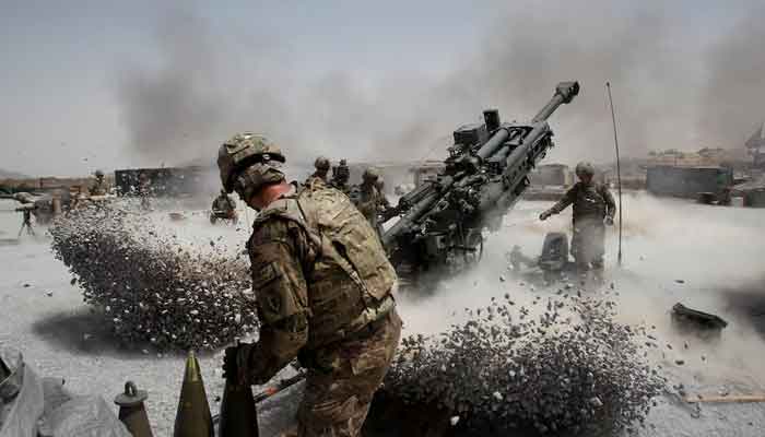 US Army soldiers from the 2nd Platoon, B battery 2-8 field artillery, fire a howitzer artillery piece at Seprwan Ghar forward fire base in Panjwai district, Kandahar province southern Afghanistan, June 12, 2011. — Reuters