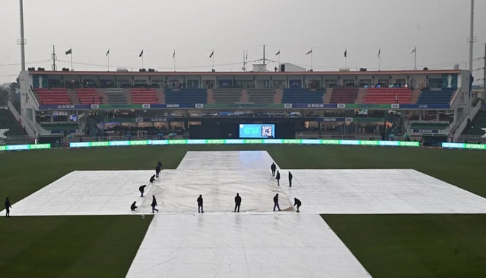 Groundstaff put on the rain covers on the pitch during the now-abandoned Champions Trophy 2025 match  between Pakistan and Bangladesh in Rawalpindi, on February 27, 2025. — AFP