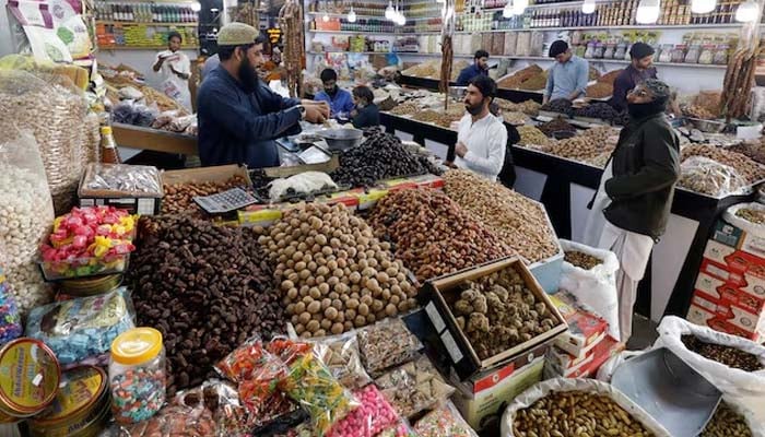 People buy dry fruits at a market in Karachi, Pakistan February 1, 2023.— Reuters