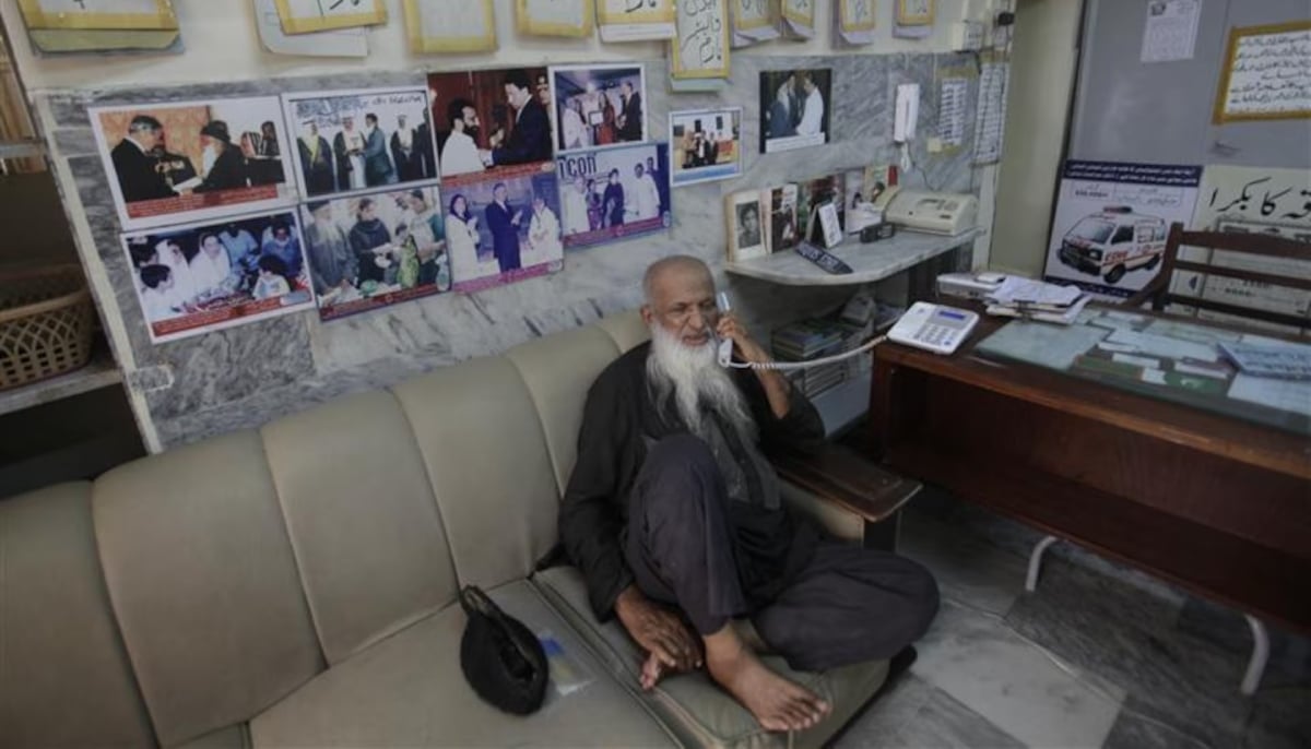 Abdul Sitar Edhi, the founder of the non-profit social welfare program the Edhi Foundation, takes a call at the main Edhi center in Karachi on June 10, 2011. — Reuters