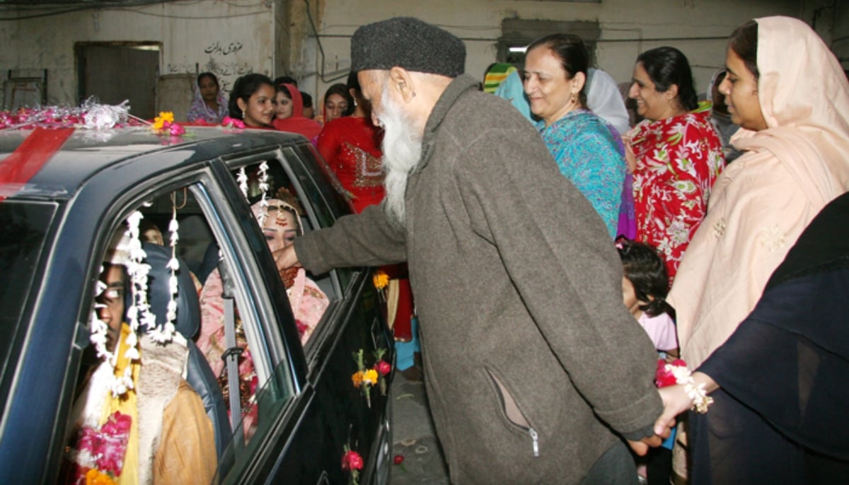 Abdul Sattar Edhi (centre) and wife Bilquis Edhi see off a girl at the orphanage after her wedding ceremony. — Edhi Foundation/File