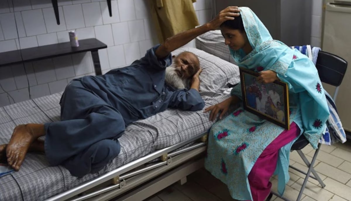 Indian woman, Geeta (right) takes blessings from Abdul Sattar Edhi, the chairman of Edhi Foundation in Karachi, October 15, 2015. — AFP