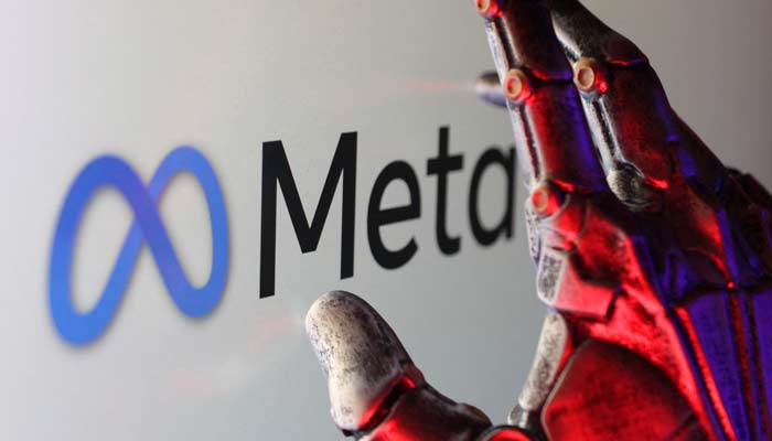 This representational image shows the Meta logo and a robotic hand. — Reuters/File